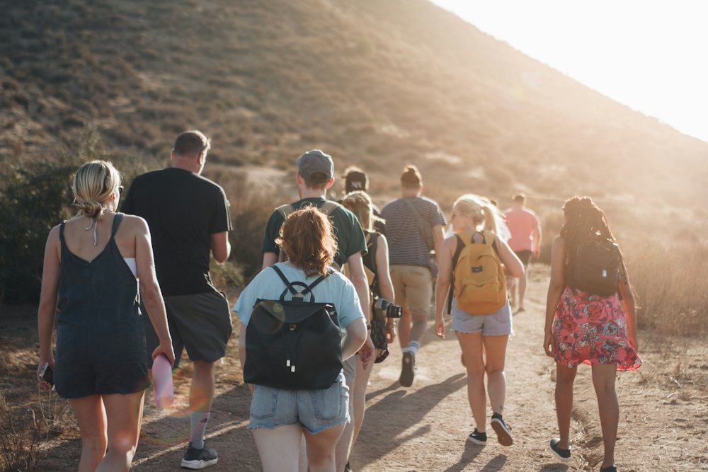 A group of travellers walking along a mountain trail