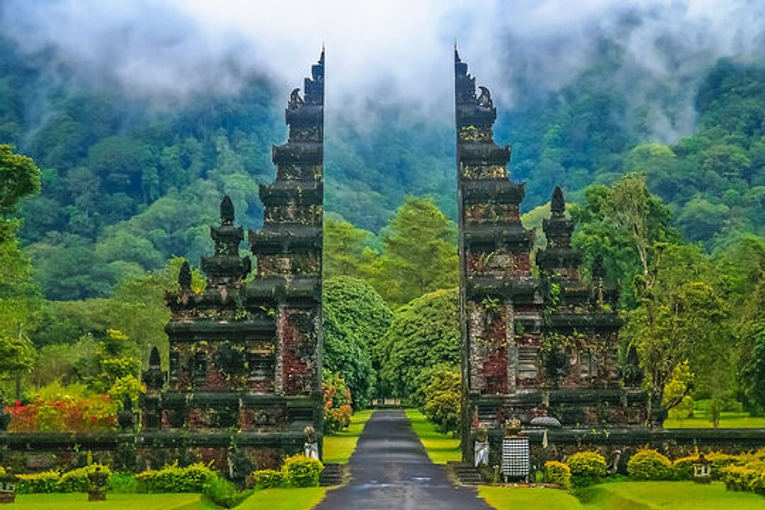 The Handara Gate framed by misty green hills, Bali, Indonesia